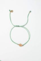 Bracelet cordon Rosa vert à plat, rose dorée sur cordon coulissant